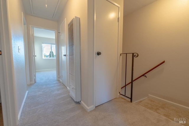 hallway featuring light colored carpet