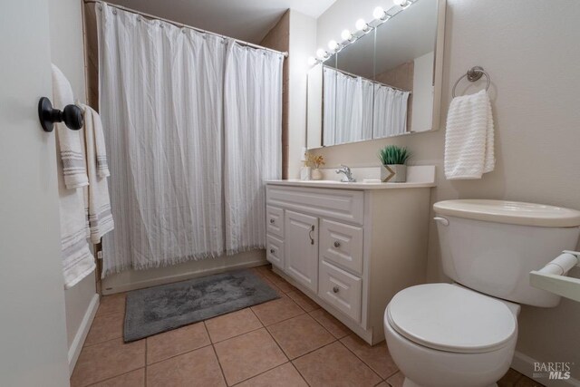 full bathroom featuring vanity, shower / tub combo, tile patterned floors, and toilet