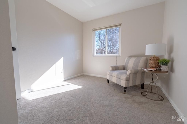 sitting room with vaulted ceiling and light carpet