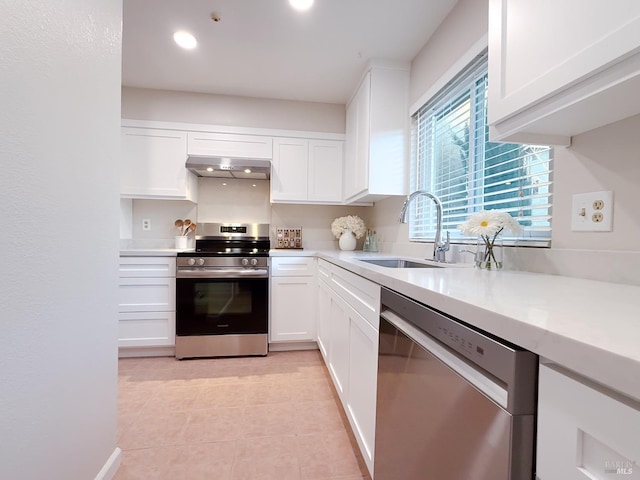 kitchen featuring stainless steel appliances, extractor fan, sink, light tile patterned floors, and white cabinets