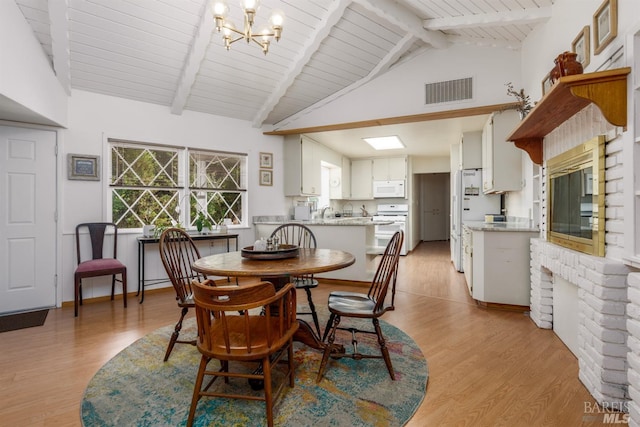 dining room with an inviting chandelier, high vaulted ceiling, beamed ceiling, wood ceiling, and light wood-type flooring