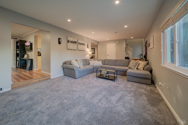 carpeted living room with crown molding