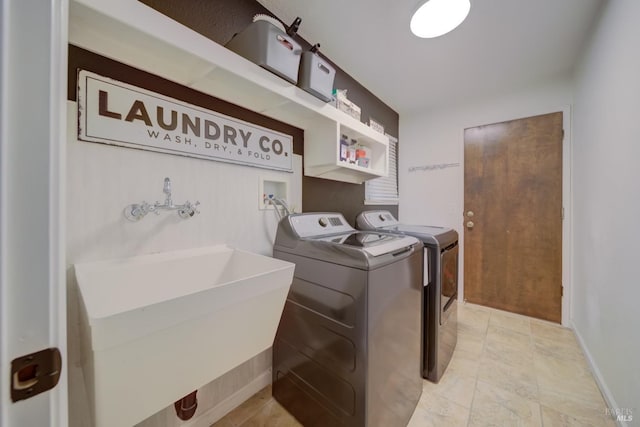 washroom featuring sink and washing machine and clothes dryer