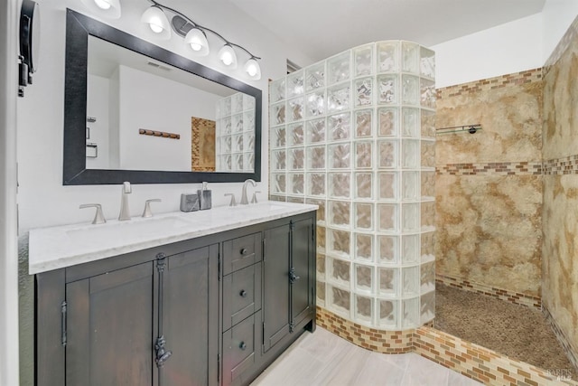 bathroom featuring vanity and tiled shower