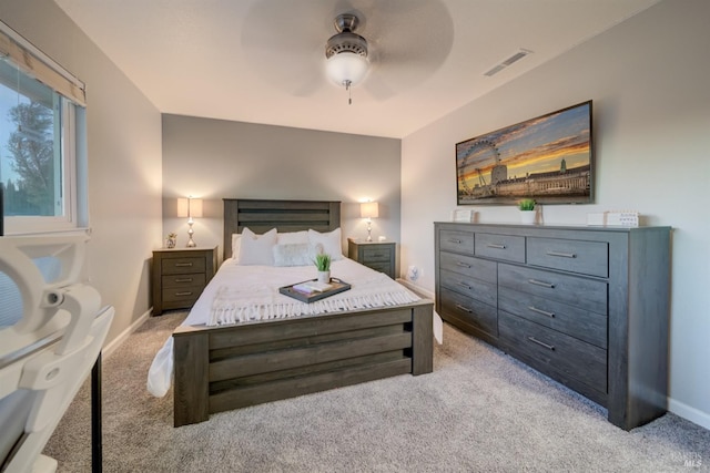 bedroom with ceiling fan and light carpet