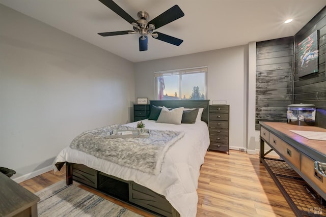 bedroom with light hardwood / wood-style flooring and ceiling fan