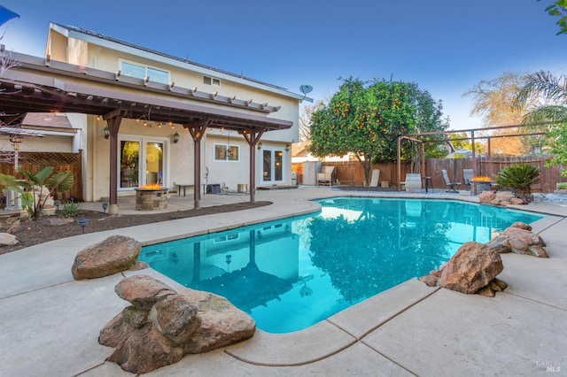 view of pool with a patio area and french doors