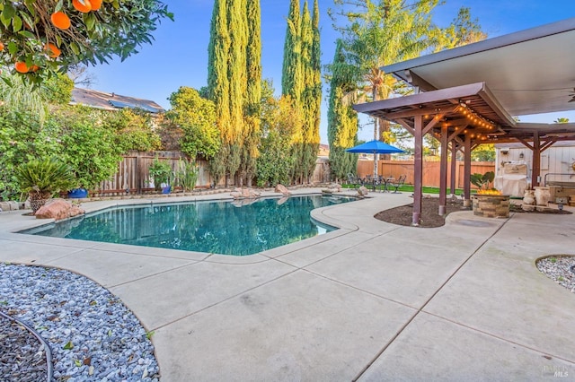 view of pool featuring ceiling fan and a patio