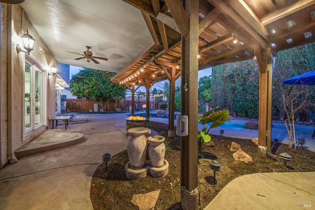 view of patio featuring a fenced in pool and ceiling fan