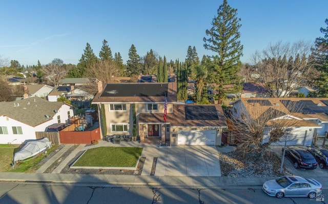 view of front of property featuring a front lawn and solar panels