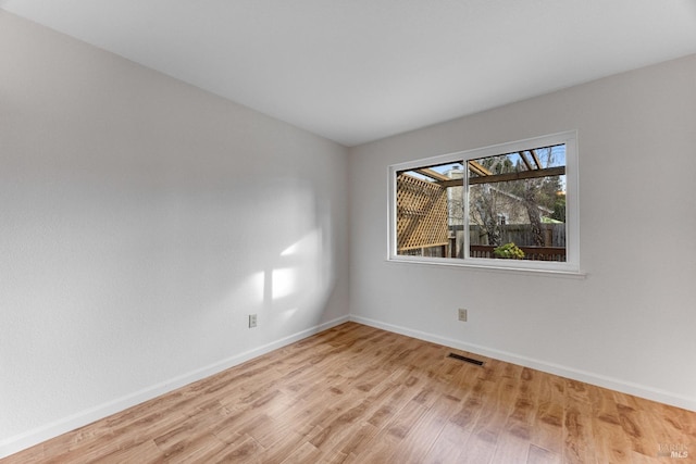 spare room featuring light hardwood / wood-style floors