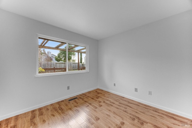 empty room with light hardwood / wood-style flooring