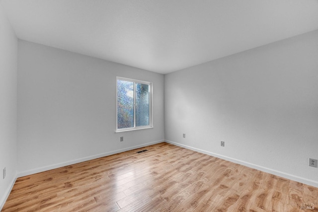 unfurnished room with light hardwood / wood-style floors