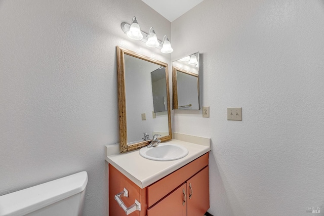 bathroom featuring vanity and toilet