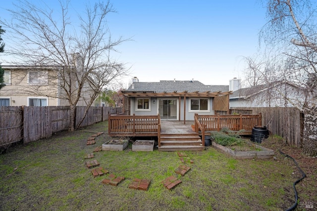 rear view of property with a lawn and a wooden deck