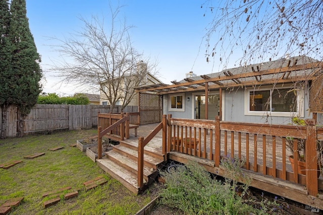 deck featuring a pergola and a yard