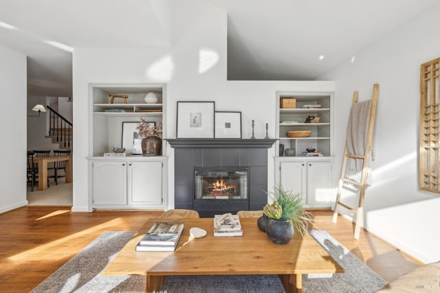 interior space featuring a fireplace, built in features, and light wood-type flooring