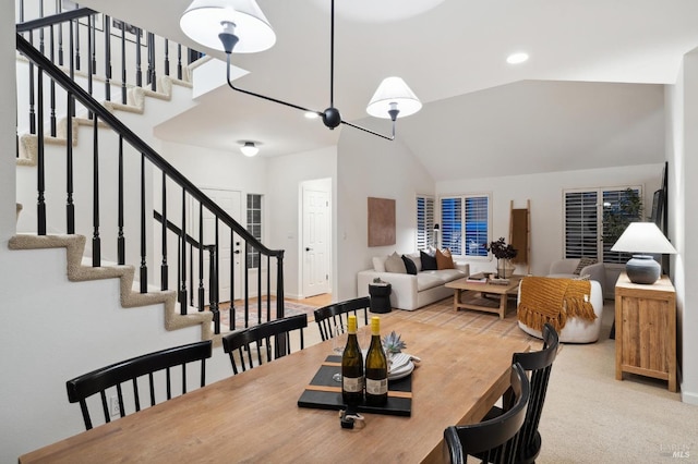 dining room featuring carpet flooring and lofted ceiling