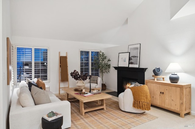 carpeted living room featuring lofted ceiling