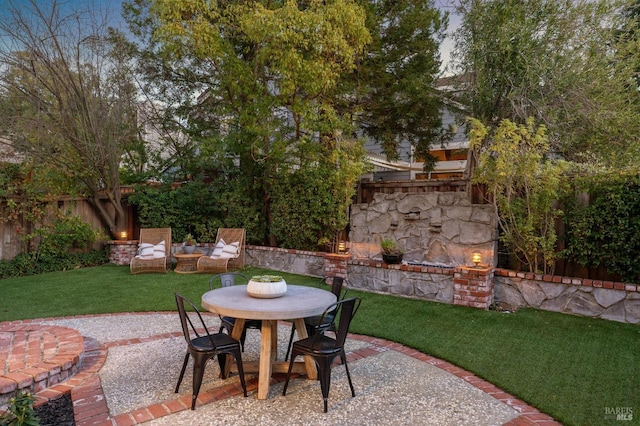 view of patio with an outdoor stone fireplace