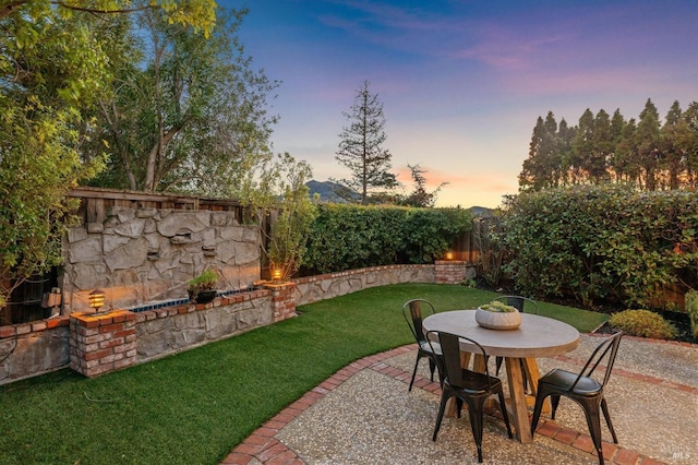 patio terrace at dusk with a yard