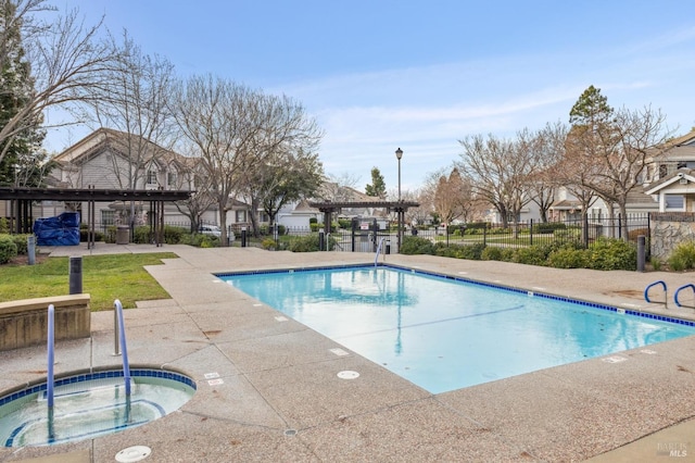 view of pool with a patio and a hot tub