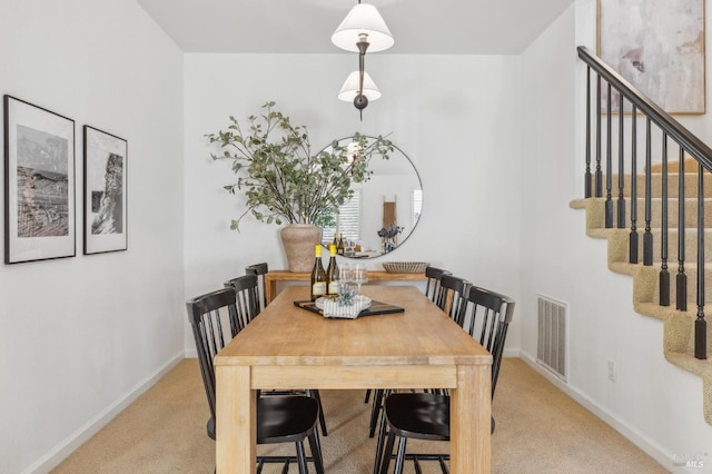 dining room featuring light carpet