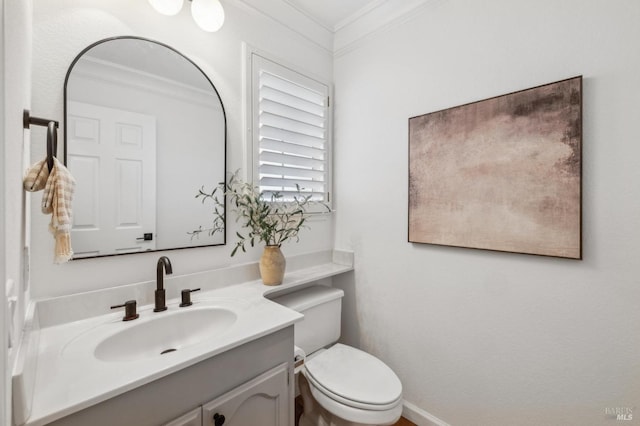 bathroom featuring vanity, toilet, and crown molding