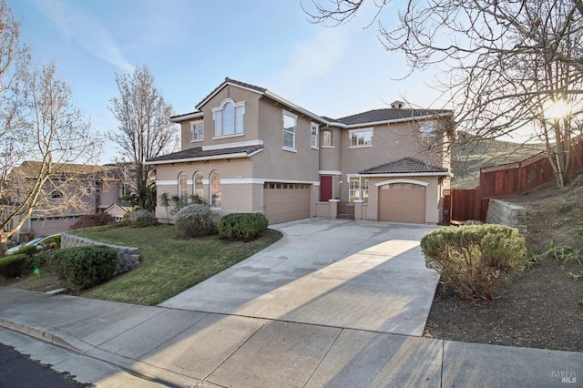 view of front of home with a front yard and a garage