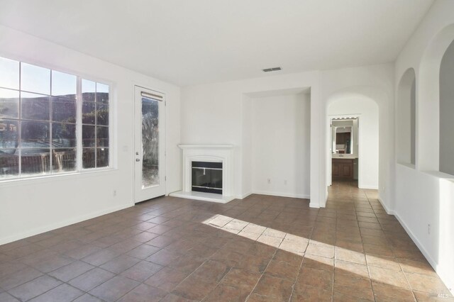 empty room featuring light colored carpet, baseboards, and visible vents