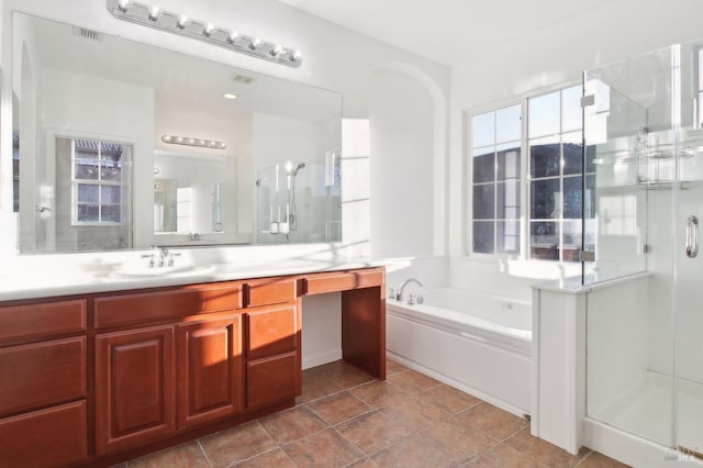 bathroom featuring vanity and independent shower and bath