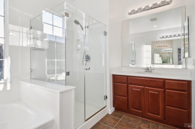 bathroom featuring vanity and independent shower and bath