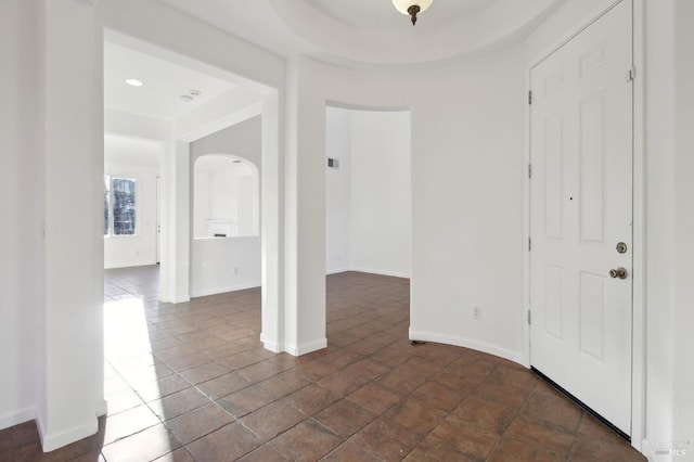 entryway featuring a tray ceiling