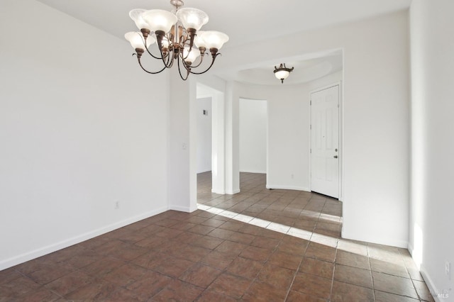 empty room with an inviting chandelier