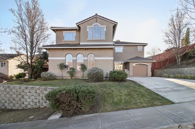 view of front of property with driveway, a front lawn, stucco siding, and fence