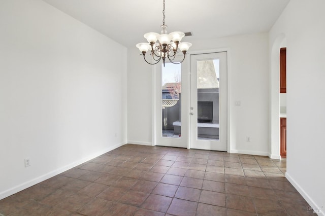 unfurnished dining area with a notable chandelier