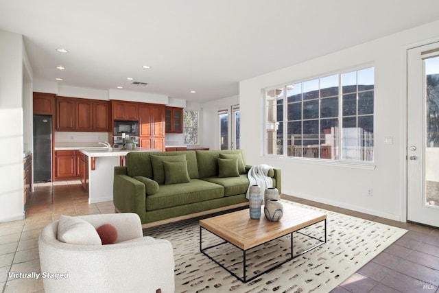 unfurnished room featuring an inviting chandelier, dark tile patterned flooring, baseboards, and arched walkways