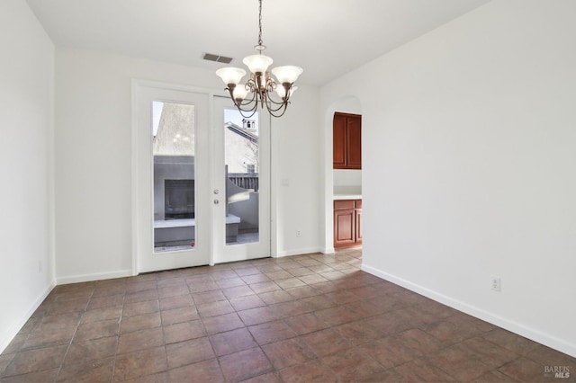 unfurnished dining area with a chandelier