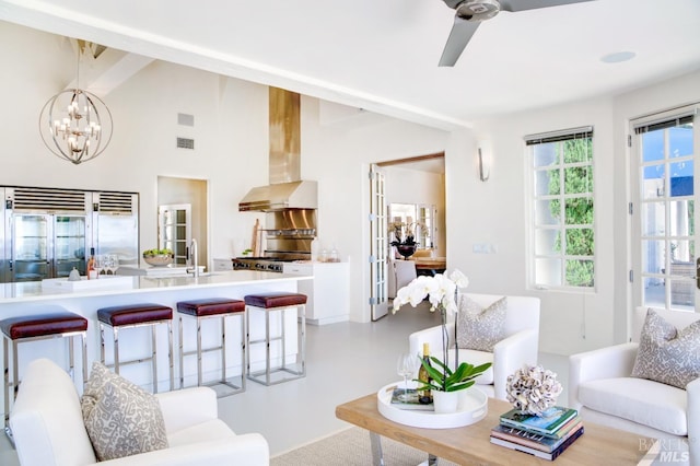 living room with high vaulted ceiling, visible vents, and ceiling fan