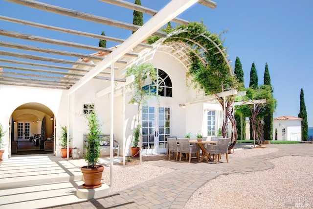 view of patio / terrace with french doors, outdoor dining area, and a pergola