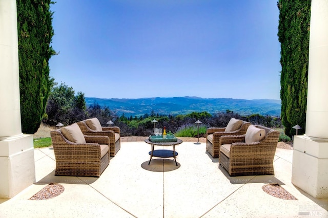 view of patio featuring a mountain view and an outdoor hangout area