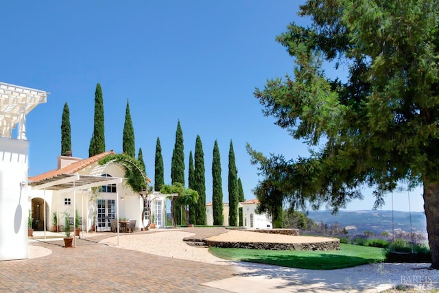 exterior space featuring french doors and a pergola