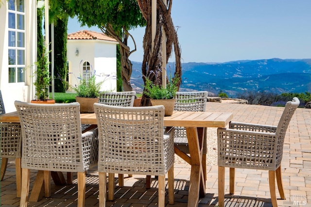 view of patio / terrace with a mountain view and outdoor dining area