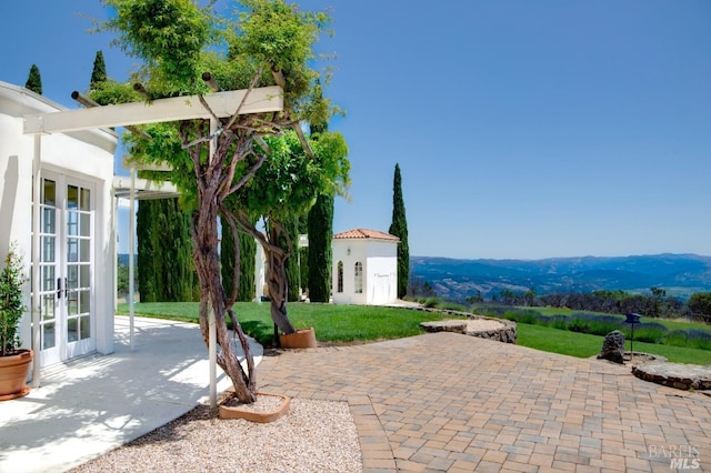 view of patio featuring a mountain view and french doors