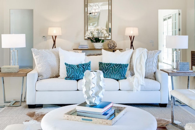 living room featuring carpet floors and a chandelier