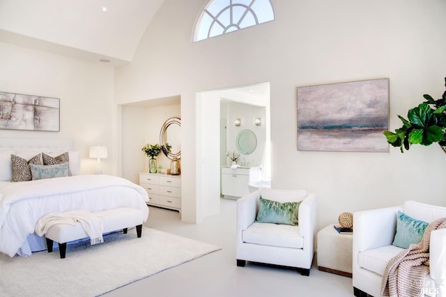 bedroom with high vaulted ceiling and connected bathroom