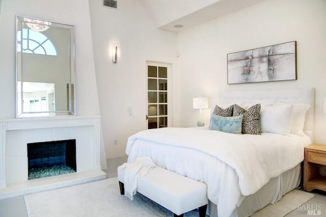 bedroom featuring a fireplace and visible vents