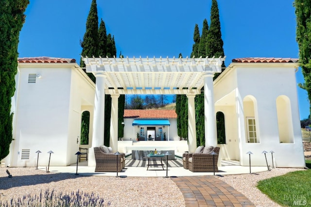 rear view of property featuring an outdoor hangout area, stucco siding, a tile roof, and a pergola