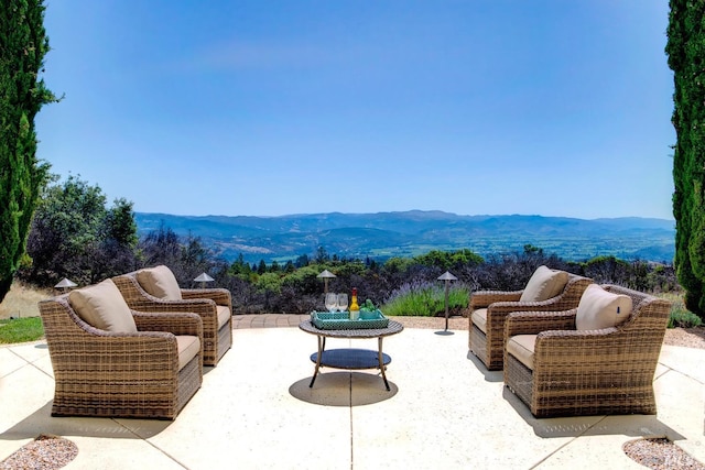 view of patio / terrace with a mountain view and an outdoor hangout area