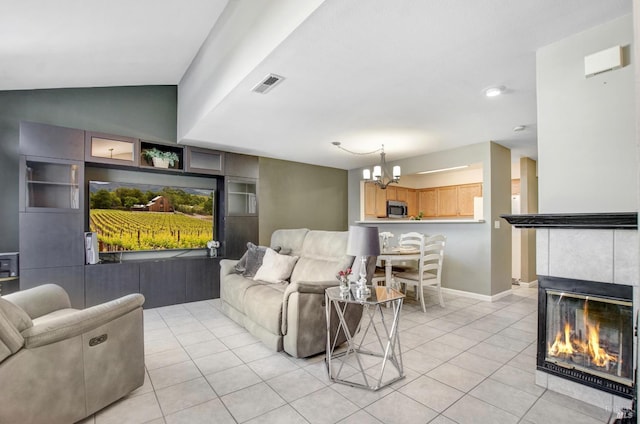 living room featuring a tile fireplace, built in shelves, vaulted ceiling, and light tile patterned flooring